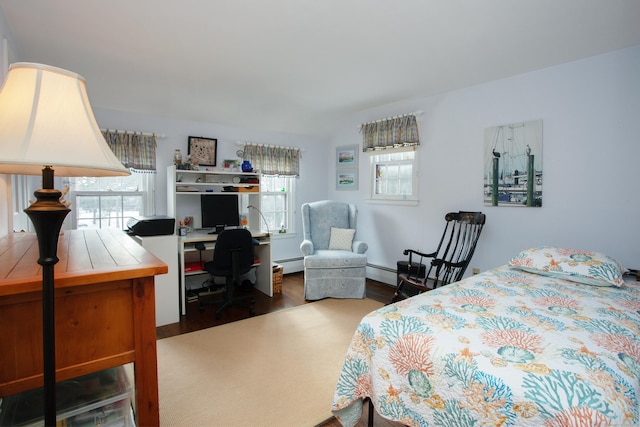 bedroom featuring dark wood-type flooring and a baseboard radiator