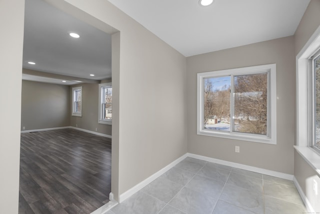 spare room featuring baseboards and recessed lighting