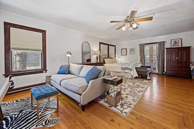 living room with light wood-style floors and a ceiling fan