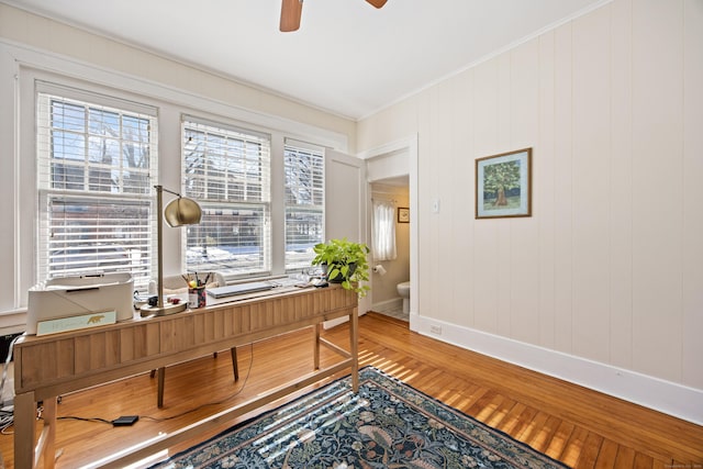 office area featuring ceiling fan, ornamental molding, wood finished floors, and a wealth of natural light