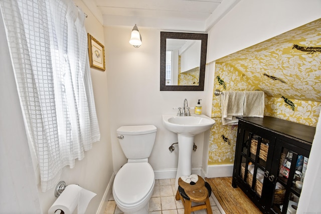 half bath with baseboards and toilet