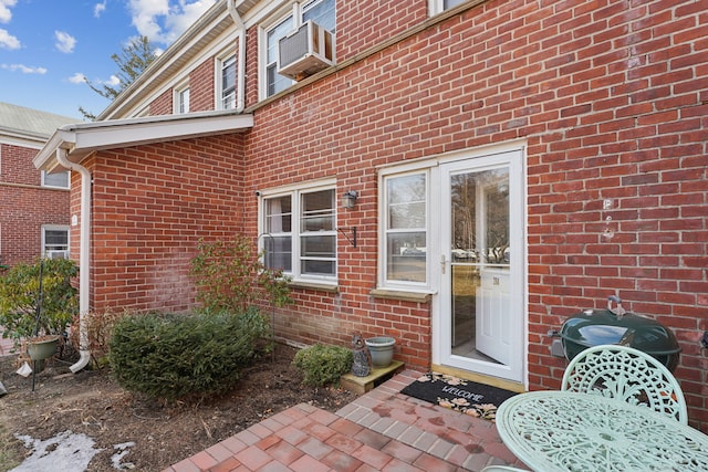 doorway to property with brick siding