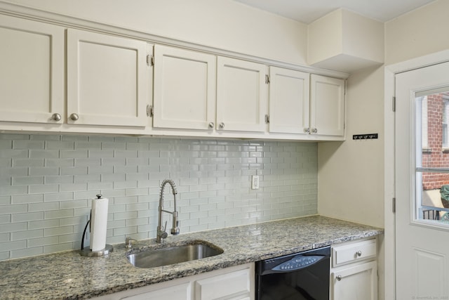 kitchen featuring tasteful backsplash, dishwasher, white cabinetry, and a sink