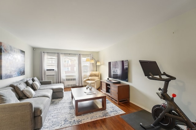 living area featuring baseboards and dark wood-style flooring