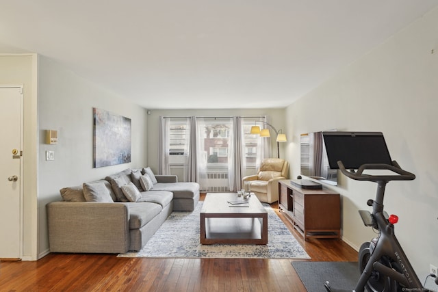 living area with radiator heating unit and dark wood-style flooring