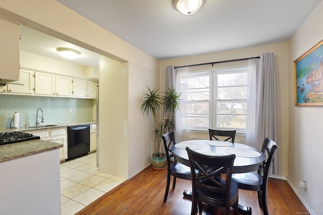 dining area featuring baseboards and light wood-style flooring