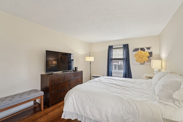 bedroom featuring dark wood-style flooring