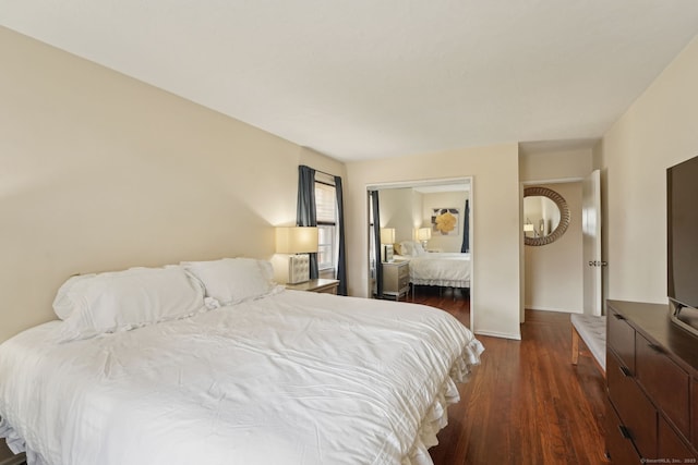 bedroom featuring dark wood-type flooring and baseboards