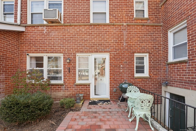 view of exterior entry with brick siding