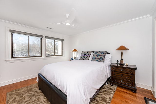 bedroom featuring ceiling fan, light hardwood / wood-style floors, and crown molding