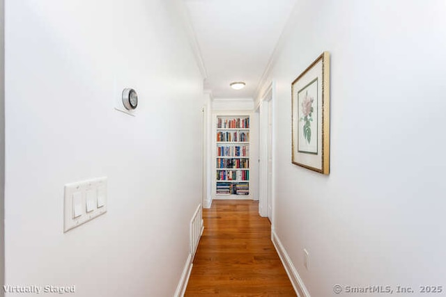 hall with hardwood / wood-style flooring