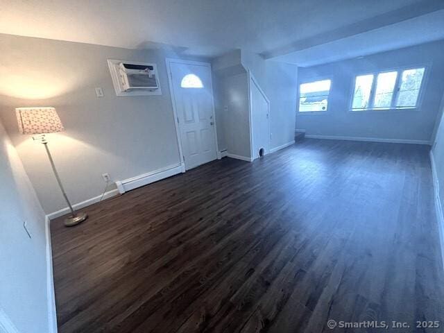 interior space featuring dark hardwood / wood-style flooring, a wall mounted AC, and a baseboard radiator