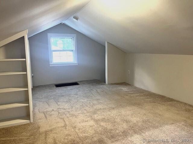 bonus room featuring lofted ceiling and carpet flooring