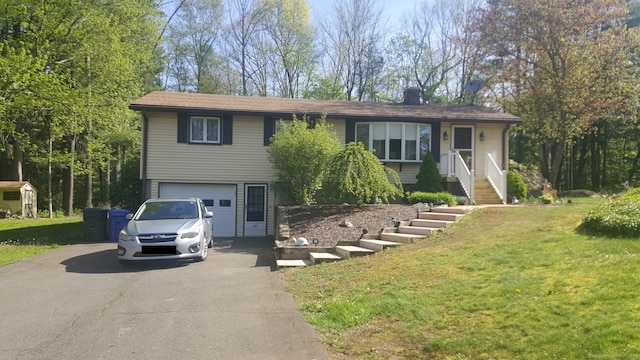 view of front of house featuring a garage and a front lawn