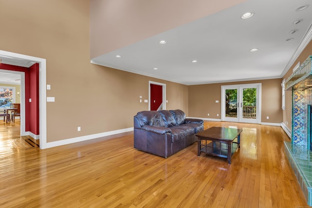 living room with french doors, ornamental molding, a baseboard radiator, and light hardwood / wood-style floors