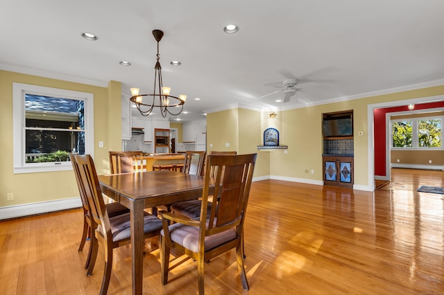 dining area with baseboard heating, ornamental molding, ceiling fan with notable chandelier, and light hardwood / wood-style floors