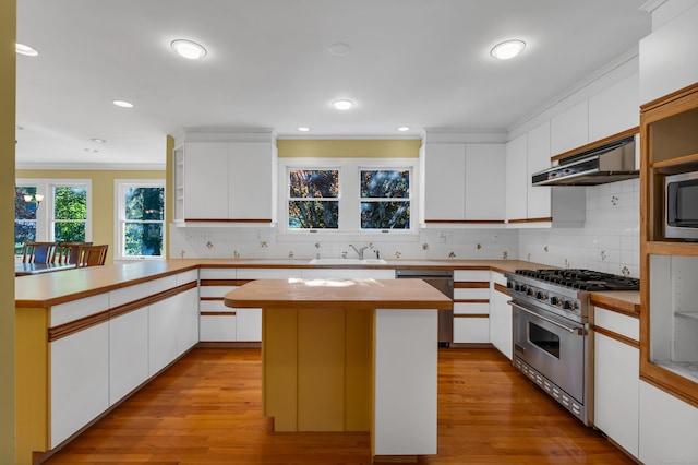 kitchen featuring white cabinetry, a kitchen island, light hardwood / wood-style floors, and appliances with stainless steel finishes