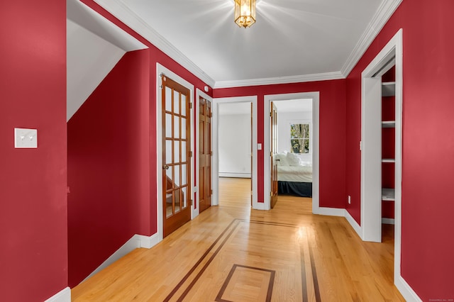 hall featuring wood-type flooring, ornamental molding, and a baseboard radiator