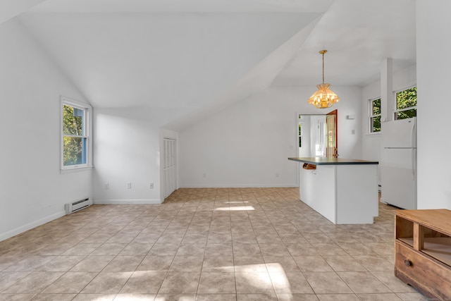 interior space featuring lofted ceiling, a notable chandelier, a baseboard radiator, and plenty of natural light