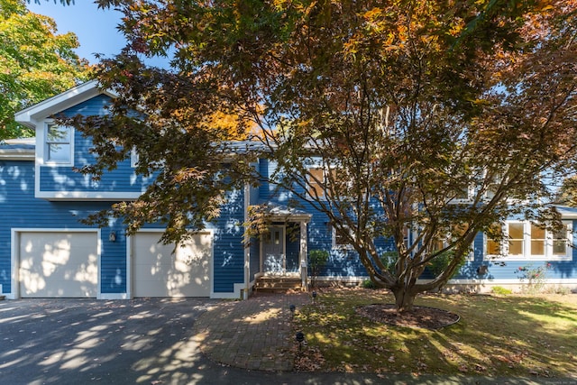 obstructed view of property with a garage