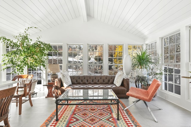 sunroom featuring lofted ceiling with beams