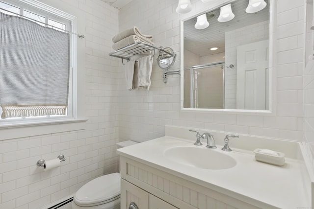 bathroom with tile walls, toilet, a shower with door, and a wealth of natural light