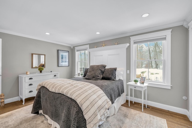 bedroom featuring light wood-style floors, recessed lighting, baseboards, and ornamental molding