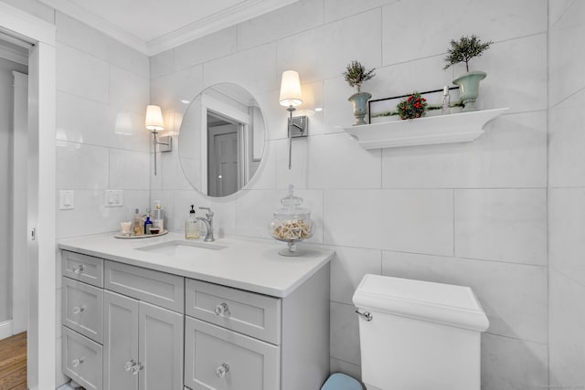 bathroom featuring tile walls, backsplash, toilet, ornamental molding, and vanity