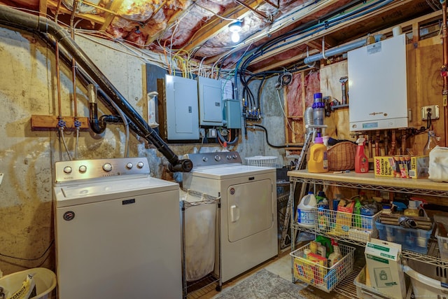 clothes washing area featuring laundry area, electric panel, and washing machine and clothes dryer