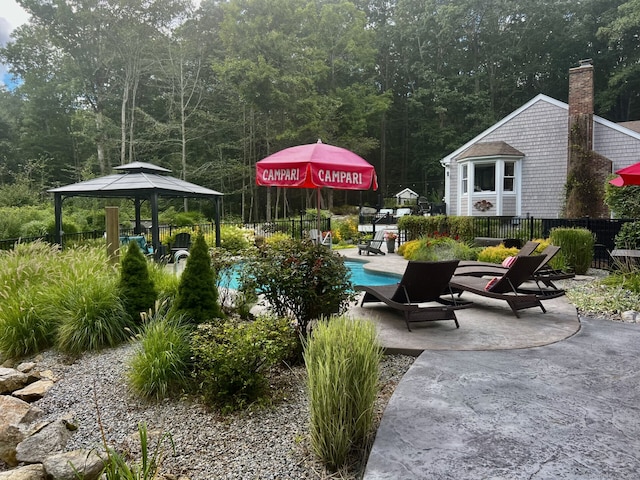 view of patio / terrace featuring a gazebo and fence