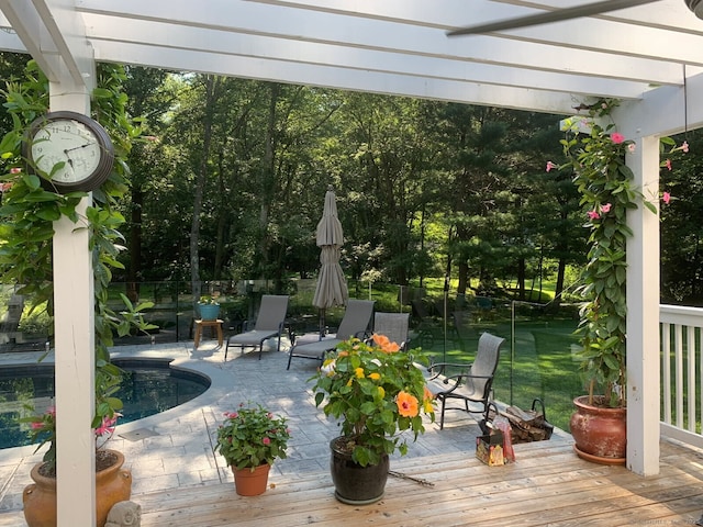 wooden deck featuring an outdoor pool, fence, and a pergola