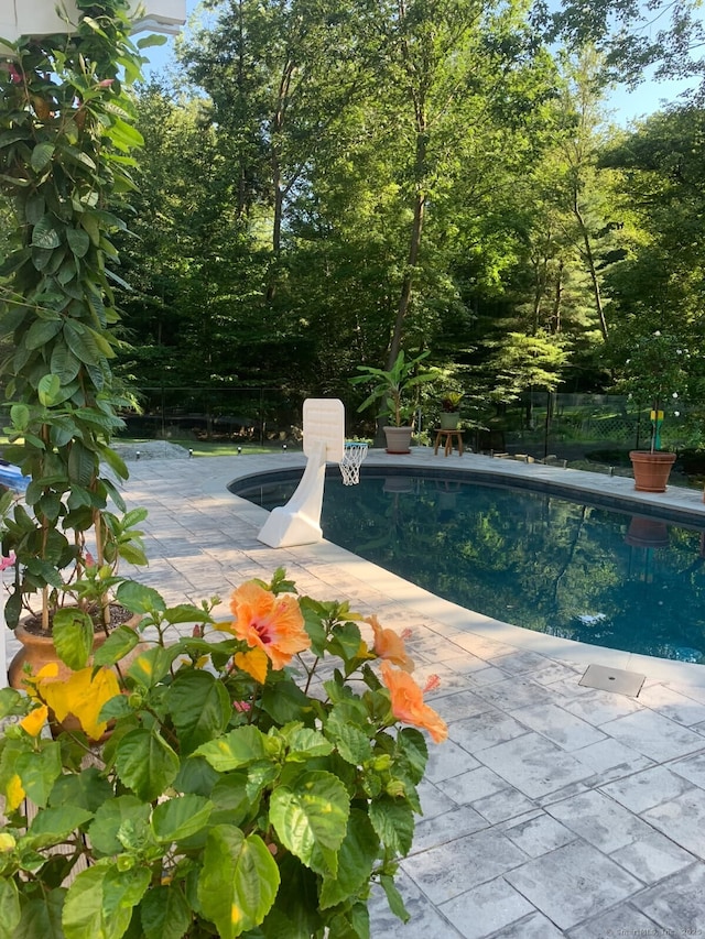 outdoor pool with a patio area