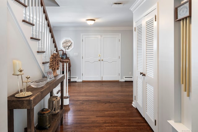 interior space featuring a baseboard heating unit, dark wood-type flooring, visible vents, stairs, and baseboard heating