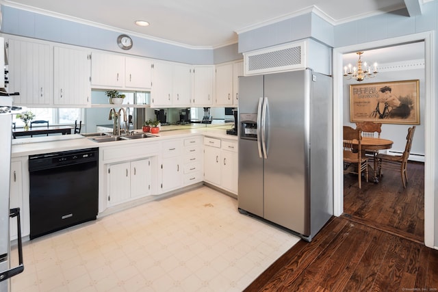 kitchen with a sink, light countertops, stainless steel refrigerator with ice dispenser, dishwasher, and decorative light fixtures