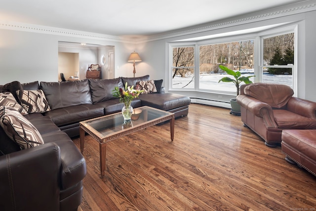 living area with ornamental molding, baseboard heating, and wood finished floors