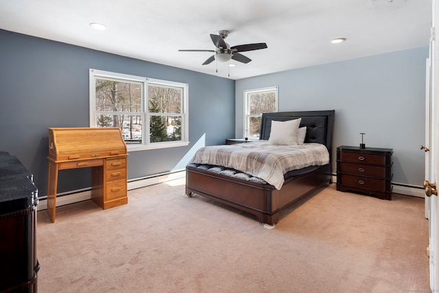 bedroom with a baseboard heating unit, baseboard heating, and light colored carpet