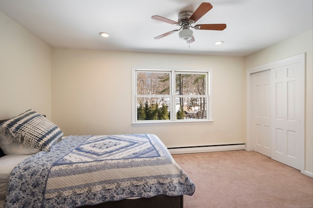 bedroom with light carpet, a closet, a baseboard radiator, and recessed lighting