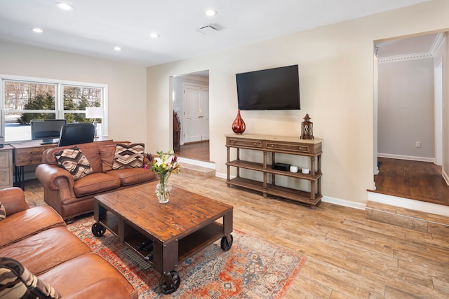 living area with baseboards, recessed lighting, visible vents, and light wood-style floors