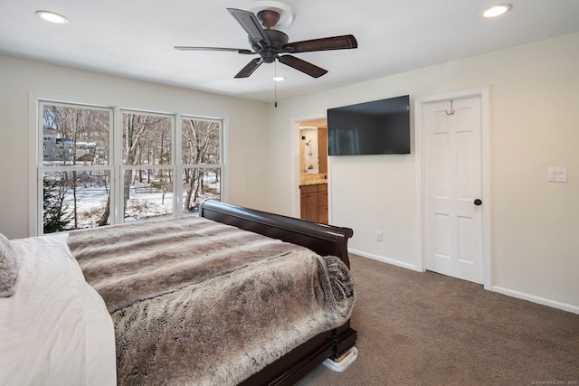 bedroom with ensuite bathroom, ceiling fan, recessed lighting, baseboards, and dark carpet