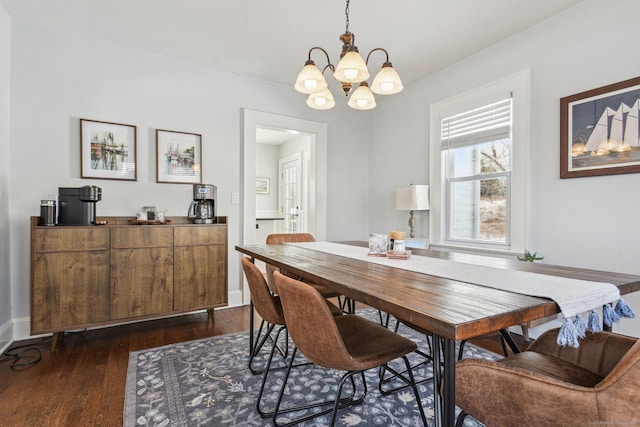 dining space with an inviting chandelier and dark hardwood / wood-style flooring