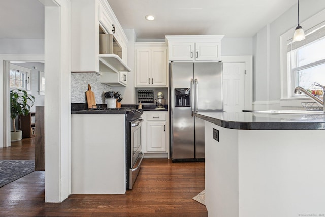 kitchen with sink, stainless steel appliances, a healthy amount of sunlight, white cabinets, and wall chimney exhaust hood