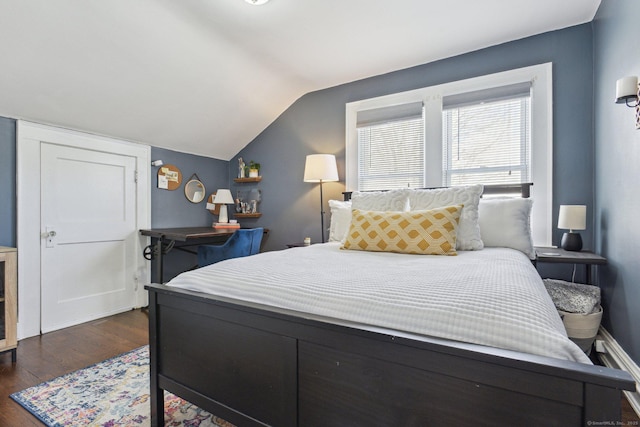 bedroom with dark wood-type flooring and lofted ceiling