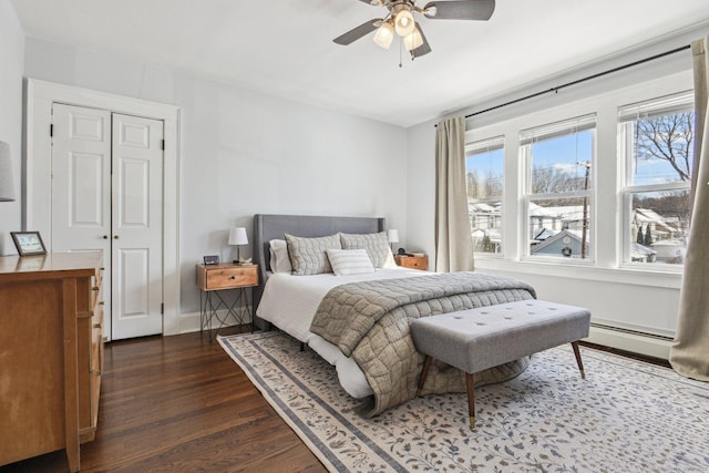 bedroom featuring a baseboard radiator, dark wood-type flooring, and ceiling fan