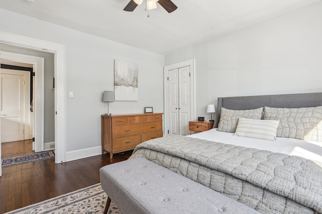 bedroom featuring dark wood-type flooring, ceiling fan, and a closet