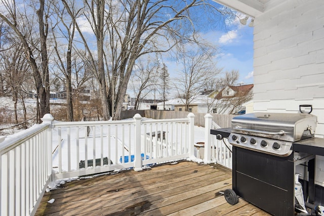 snow covered deck with a grill