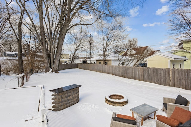 yard layered in snow featuring a fire pit