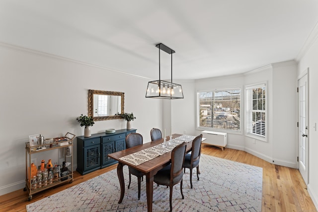 dining room featuring light hardwood / wood-style floors and ornamental molding