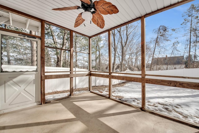 unfurnished sunroom featuring a ceiling fan