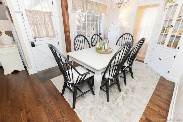 dining room featuring an inviting chandelier and dark hardwood / wood-style floors