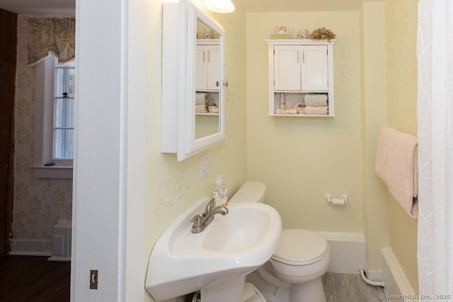 bathroom featuring hardwood / wood-style flooring, toilet, and sink